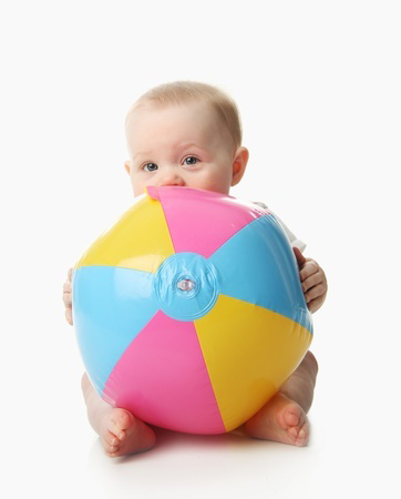 Adorable baby playing with a colorful beach ball, isolated on white @Tera Christianson